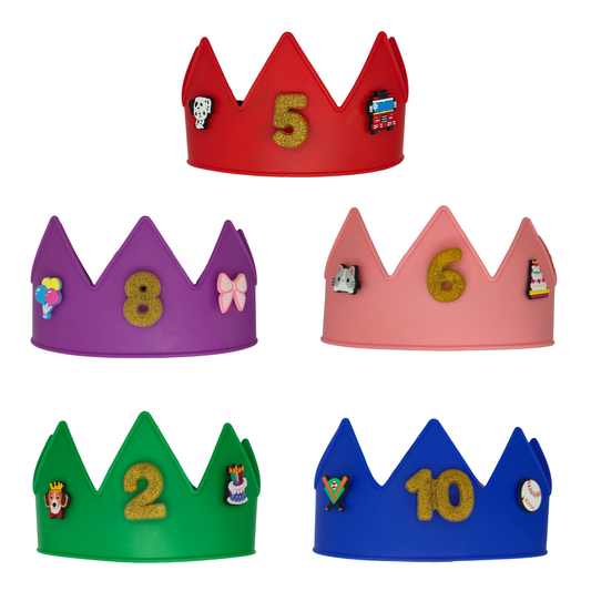 Five colorful birthday crowns for kids in a  (red, purple, pink, green, and blue) and decorated with a large glittery gold birthday number and show charms. Removable charms to decorate the crowns for birthdays, dress up, costumes or classrooms.